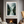 Framed wall art of evergreens, river, and mist in soft watercolours. A calm woodland scene, ready to hang.