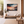 Framed canvas wall art of a glowing sunset and solitary boat. A calm seascape in warm hues, ready to hang.