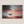 Canvas wall art of a lone boat on calm twilight seas. Soft blues and warm oranges create a peaceful ocean print, ready to hang.