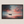 Canvas wall art of a lone boat on calm twilight seas. Soft blues and warm oranges create a peaceful ocean print, ready to hang.