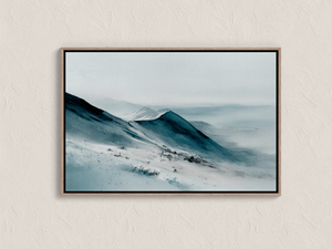Framed mountain canvas wall art with snowy peaks and soft blue grey tones
