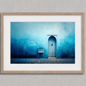 Framed fine art print of a Moroccan blue doorway. Minimalist travel-inspired wall art full of calm, texture, and timeless charm.