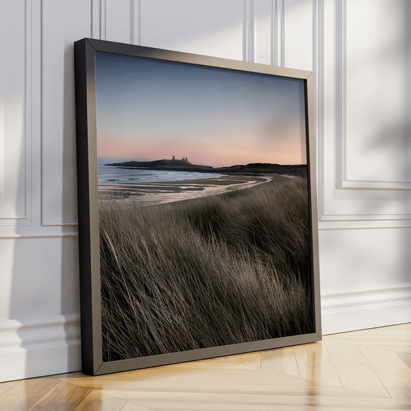 Serene Northumberland Castle at sunset with seagrass and tidal reflections — a tranquil wall art print for peaceful, coastal-inspired interiors.