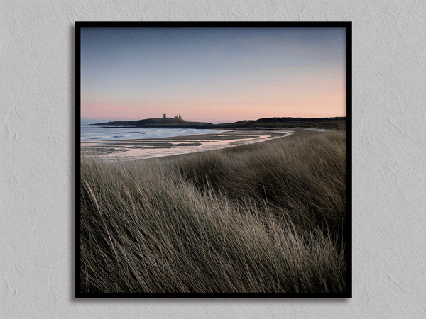 Serene Northumberland Castle at sunset with seagrass and tidal reflections — a tranquil wall art print for peaceful, coastal-inspired interiors.