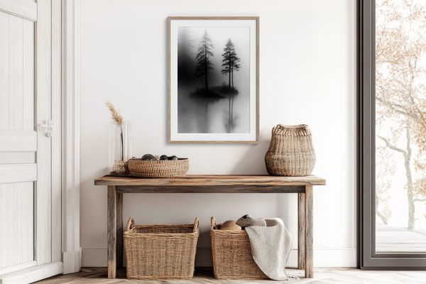 Framed wall art of two lone pines reflected in misty waters. A monochrome forest print evoking solitude and calm. Ready to hang.