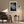 Light-framed dew-covered leaf wall art above an armchair and side table with a floor lamp.