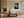 Light wood-framed dew-covered leaf wall art above a cream sofa and low wooden coffee table.
