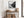 Black-framed Mistwater Valley river print above a rustic console with woven baskets.