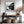 Black-framed misty river artwork above a wood-and-metal console beside a staircase.