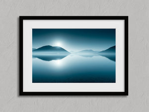 Blue mountain lake print with white mat in a black frame against a textured gray wall.