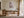 Light wood-framed cherry blossom print displayed above a wooden desk and chair.