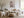Light wood-framed cherry blossom print above a cream sofa and wooden coffee table.