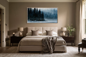 Framed winter lake and evergreen artwork above a beige bed with dark wood nightstands.
