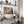 Framed geometric orange fox wall art above a wood desk with shelves, lamp, and pampas grass.