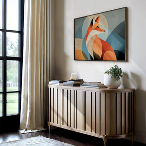 Thin dark-framed geometric fox print above a slatted console table with stacked books and a potted plant.