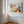 Light wood-framed geometric fox print displayed on a white paneled wall near tall windows.