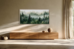 Framed misty pine forest watercolor above a long wooden sideboard beside full-length curtains.