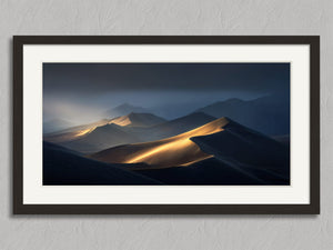 Light Across the Dunes shown in a black frame with a white border or mount.