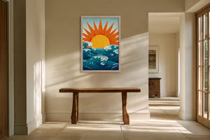 Framed golden sun rising over teal waves illustration above a rustic wooden console table.