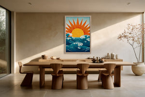 Framed golden sun and teal wave illustration above a long wooden dining table.