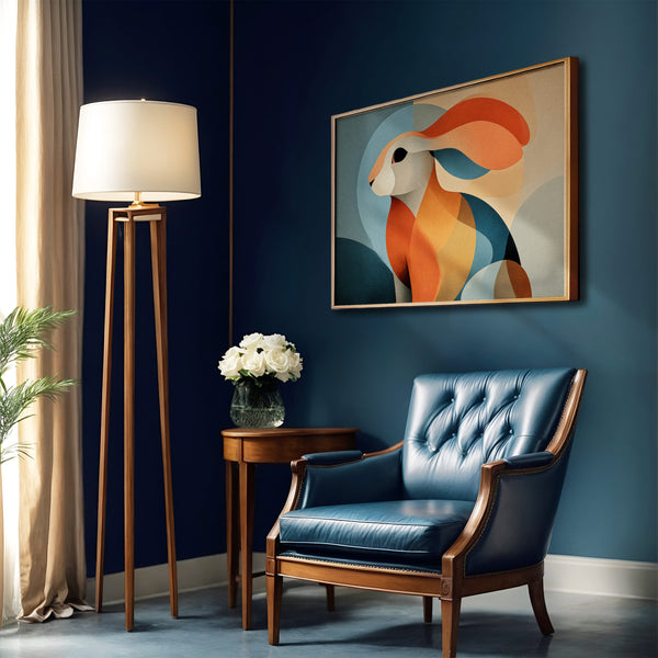 Framed abstract hare artwork on a dark blue wall above a blue leather armchair.