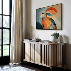 Thin dark-framed abstract hare print above a slatted console with books and a potted plant.
