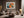 Light-framed abstract hare artwork above a cream sectional with a round wood coffee table.