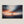 Canvas wall art of a sailboat at sunset with stormy skies. A dramatic ocean print balancing calm and intensity. Ready to hang.