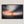 Canvas wall art of a sailboat at sunset with stormy skies. A dramatic ocean print balancing calm and intensity. Ready to hang.