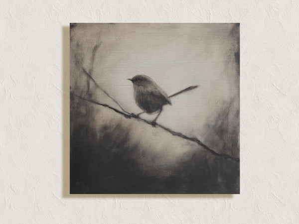 Canvas wall art of a solitary robin in black and white. A peaceful charcoal bird print, full of stillness. Ready to hang.