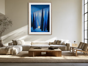 White-framed forest artwork centered above a cream sectional sofa in a sunlit living area.