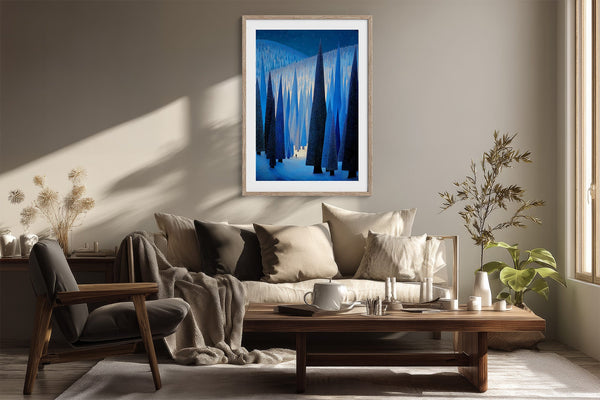 White-framed blue forest artwork above a cream sofa and wooden coffee table.