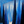 Illustrated blue night forest with tall dark conifers, a small figure on a snowy path and stars overhead