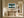 Leaning Light tree artwork in a pale wood frame above a rustic wooden console table.