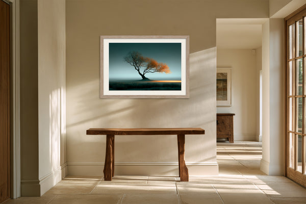 Leaning Light tree artwork in a pale wood frame above a rustic wooden console table.