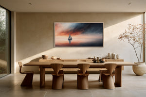 Framed sailboat artwork displayed above a long wooden dining table with sculptural chairs.