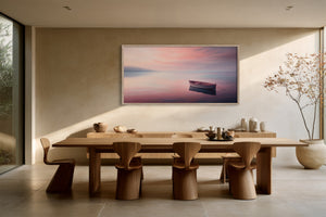 White-framed rowboat artwork above a long wooden dining table with sculptural chairs.