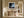 Framed misty coastal artwork above a rustic wooden bench in a sunlit hallway.
