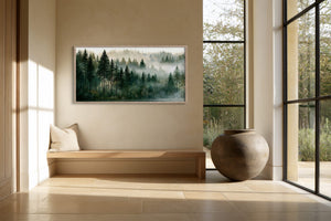 Framed misty forest artwork above a built-in bench beside tall black-framed windows.