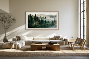 Framed misty conifer forest artwork above a cream sectional sofa and wooden coffee table.