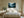 Light wood-framed misty conifer forest artwork centered above a bed between two nightstands.