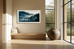 Framed misty conifer forest artwork above a built-in bench beside large windows.
