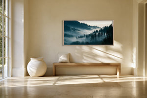 Framed conifer forest landscape above a wooden bench, with sunlight across the floor.