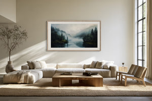 Light-framed misty forest lake artwork above a sectional sofa and wooden coffee table.
