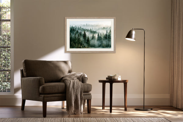 Light wood-framed evergreen forest artwork above a dark upholstered armchair and side table with floor lamp.
