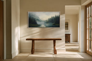 Light wood-framed mountain river artwork above a rustic wooden bench in a sunlit hallway.