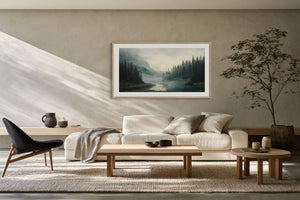 Mist Between the Pines in a pale wood frame above a cream sofa, coffee tables, and a black lounge chair.