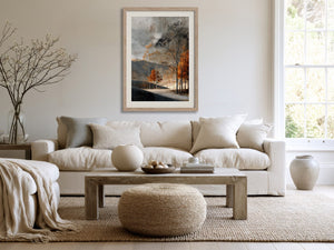 Light wood-framed autumn woodland print above a cream sofa and wood coffee table.