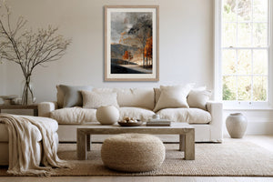 Light wood-framed autumn woodland print above a cream sofa and wood coffee table.