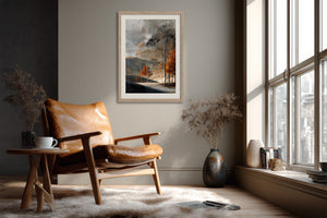 Light wood-framed autumn trees print above a leather lounge chair beside tall windows.